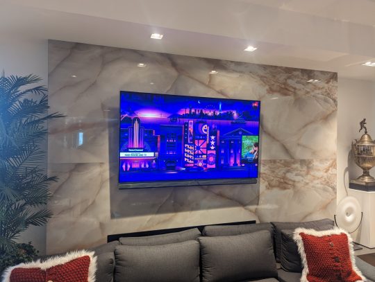 TV installed on ceramic tile wall