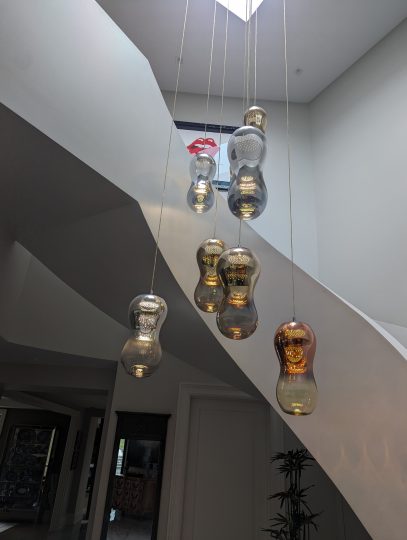 Beautiful modern chandelier and staircase